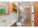 Bathroom featuring a vanity, toilet, cabinet, and glass-enclosed shower at 497 Fire Fly Dr, Tucker, GA 30084