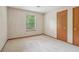 Cozy carpeted bedroom features a window and closet for optimal storage at 497 Fire Fly Dr, Tucker, GA 30084