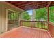 View of the wooden deck with railings overlooking a lush green lawn and mature trees at 497 Fire Fly Dr, Tucker, GA 30084