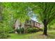 Lovely two-story home with stone accents, bay window, and lush green surroundings at 497 Fire Fly Dr, Tucker, GA 30084