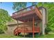 Exterior of home with a two-story deck and staircase surrounded by lush greenery at 497 Fire Fly Dr, Tucker, GA 30084