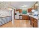 Classic kitchen with vintage-themed wallpaper, wood cabinetry, and stainless steel appliances at 497 Fire Fly Dr, Tucker, GA 30084