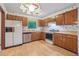 Kitchen featuring stainless appliances, wood cabinets, and laminate floor at 497 Fire Fly Dr, Tucker, GA 30084