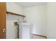 Bright laundry room with white washer and a shelf with wooden trim at 497 Fire Fly Dr, Tucker, GA 30084