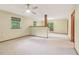 Spacious living room with natural light, ceiling fan, and carpeted floor at 497 Fire Fly Dr, Tucker, GA 30084