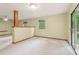 A spacious living room with a sliding glass door to the deck, neutral paint, and carpet at 497 Fire Fly Dr, Tucker, GA 30084