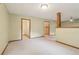 An open living room featuring carpet flooring and access to hallways and rooms at 497 Fire Fly Dr, Tucker, GA 30084