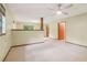 Bright living room featuring neutral paint, carpeted floor, and ceiling fan at 497 Fire Fly Dr, Tucker, GA 30084