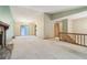 Spacious living room features a fireplace, sliding glass door and staircase to upper level at 497 Fire Fly Dr, Tucker, GA 30084