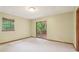 Carpeted room with a sliding glass door leading to a deck and an exterior view at 497 Fire Fly Dr, Tucker, GA 30084