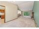 Open living room with large windows, fireplace, and entry to the kitchen at 497 Fire Fly Dr, Tucker, GA 30084