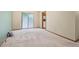 Living room includes neutral carpet, sliding glass doors and trim throughout at 497 Fire Fly Dr, Tucker, GA 30084