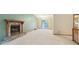 Large living room with a stone fireplace, neutral carpet, and access to outdoor space at 497 Fire Fly Dr, Tucker, GA 30084
