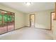 A room with sliding glass doors leading to the deck and a doorway to another room at 497 Fire Fly Dr, Tucker, GA 30084