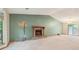 Spacious living room featuring a stone fireplace, neutral carpet, and natural light at 497 Fire Fly Dr, Tucker, GA 30084