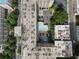 Aerial view of building, parking, trees, streets, and in-ground pool with lounge furniture at 878 Peachtree St # 601, Atlanta, GA 30309