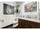 Elegant bathroom featuring wood vanity, marble countertop, illuminated mirror, and modern fixtures with industrial accents at 878 Peachtree St # 601, Atlanta, GA 30309