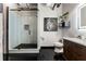 Sleek bathroom featuring tiled shower with glass door, marble vanity, and modern fixtures with industrial-style elements at 878 Peachtree St # 601, Atlanta, GA 30309