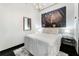 Modern bedroom with large art piece above bed, industrial-style lighting, and sleek design at 878 Peachtree St # 601, Atlanta, GA 30309