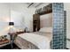 Modern bedroom featuring a murphy bed, stylish brick partition wall, and contemporary decor, creating a cozy space at 878 Peachtree St # 601, Atlanta, GA 30309