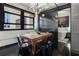 Modern dining area with industrial lighting, wooden table, and views from the windows at 878 Peachtree St # 601, Atlanta, GA 30309