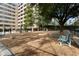 Fenced dog park area with gravel and benches beside the building at 878 Peachtree St # 601, Atlanta, GA 30309