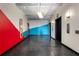 Apartment hallway with vibrant red and blue geometric accent wall and elevator access at 878 Peachtree St # 601, Atlanta, GA 30309