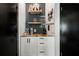 Built-in coffee bar with ATL decor, white cabinets and black hardware at 878 Peachtree St # 601, Atlanta, GA 30309