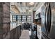 Open-concept kitchen with island, granite countertops, stainless steel appliances, and adjacent dining area at 878 Peachtree St # 601, Atlanta, GA 30309