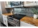 Close up of a kitchen featuring stainless steel appliances, granite countertops, and modern tile backsplash at 878 Peachtree St # 601, Atlanta, GA 30309