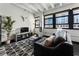 Contemporary living room with dark leather sofa, floor to ceiling windows, and black and white patterned rug at 878 Peachtree St # 601, Atlanta, GA 30309