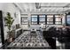 Bright living room with a modern rug, exposed ceiling, comfortable seating and lots of natural light at 878 Peachtree St # 601, Atlanta, GA 30309