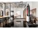 Office space features a desk and office chair and dark stained floors, exposed beams and bar seating at 878 Peachtree St # 601, Atlanta, GA 30309