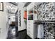 Spacious walk-in closet with custom shelving, drawers, and decorative wallpaper, with easy access to an industrial-style bathroom at 878 Peachtree St # 601, Atlanta, GA 30309