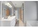 Bathroom featuring double sinks, large mirror with lights and a combination shower and tub at 1645 Four Notch Rd, Carrollton, GA 30116