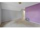 A purple accent wall and gray walls create a unique design in this carpeted bedroom at 1645 Four Notch Rd, Carrollton, GA 30116