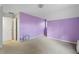 Bedroom with purple accent wall, carpeted floors, and access to a walk-in closet at 1645 Four Notch Rd, Carrollton, GA 30116