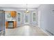 Bright dining area with tile floors and modern lighting, adjacent to the kitchen at 1645 Four Notch Rd, Carrollton, GA 30116