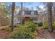 Front exterior of home featuring dormer windows, bright red front door, and a covered porch at 1645 Four Notch Rd, Carrollton, GA 30116