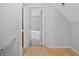 Hallway featuring wood floors and leads to bedroom at 1645 Four Notch Rd, Carrollton, GA 30116