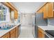 Bright kitchen with stainless steel appliances, wooden cabinets, and tile flooring at 1645 Four Notch Rd, Carrollton, GA 30116