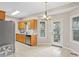 Well-lit kitchen features stainless steel appliances, wooden cabinets, and tile flooring at 1645 Four Notch Rd, Carrollton, GA 30116