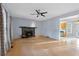 Cozy living room features a fireplace, ceiling fan, neutral paint, and wood floors at 1645 Four Notch Rd, Carrollton, GA 30116