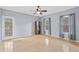 Bright living room featuring hardwood floors, a ceiling fan, and natural light from multiple windows at 1645 Four Notch Rd, Carrollton, GA 30116