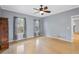 Bright living room featuring hardwood floors, a ceiling fan, and natural light from multiple windows at 1645 Four Notch Rd, Carrollton, GA 30116