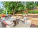 Inviting patio area with comfortable seating, a dining table, and lush landscaping at 2865 Winter Rose Ct, Dunwoody, GA 30360
