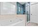Bright bathroom featuring a tub and shower combination with stylish tiling and modern fixtures at 2865 Winter Rose Ct, Dunwoody, GA 30360