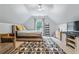 Charming bedroom featuring a vaulted ceiling, stylish rug, ladder bookcase, and comfortable furnishings at 2865 Winter Rose Ct, Dunwoody, GA 30360
