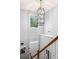 Entryway with high ceilings, a modern light fixture, staircase with wood railing, and artwork on the wall at 2865 Winter Rose Ct, Dunwoody, GA 30360