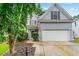 Charming two-story home with a two-car garage, an American flag, and a well-manicured front yard at 2865 Winter Rose Ct, Dunwoody, GA 30360